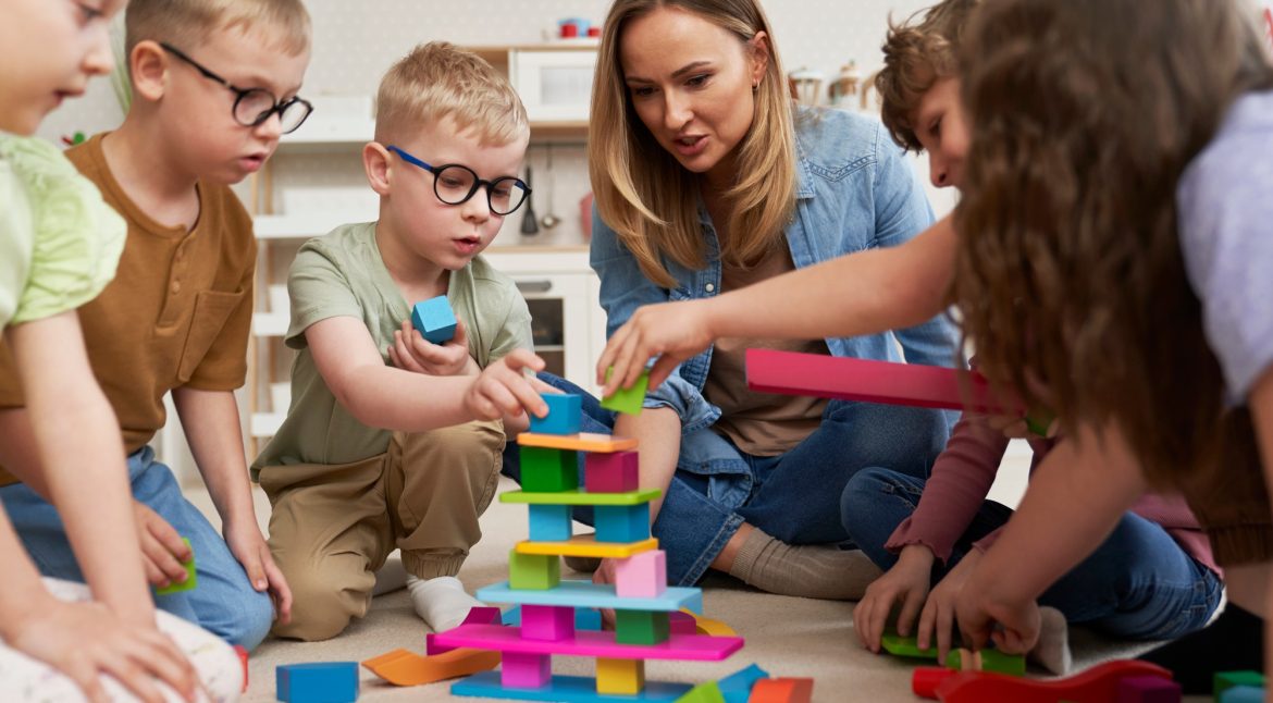 Children playing with toy blocks in the kindergarten