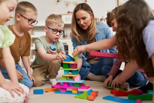 Children playing with toy blocks in the kindergarten