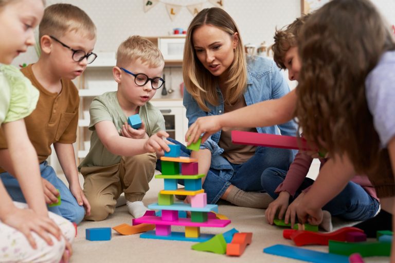 Children playing with toy blocks in the kindergarten